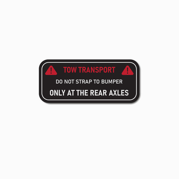 Bumper decal cover with warning label for tow truck drivers.